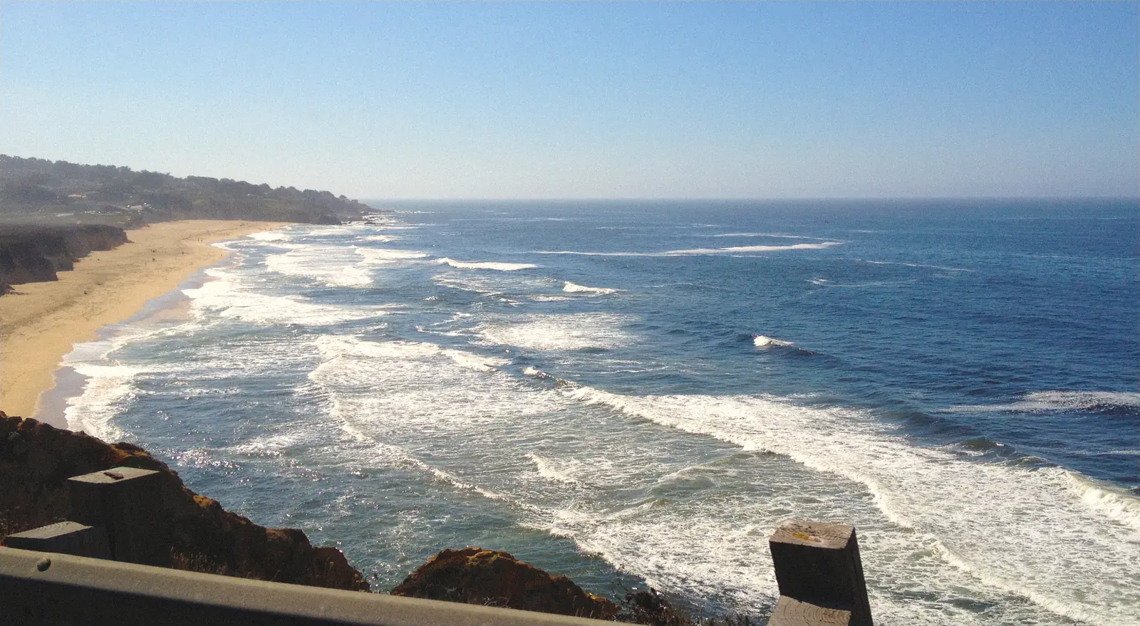 Photo of surf and a long beach seen from Route 1 near Pacifica
